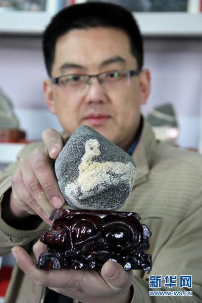 1月19日，奇石收藏爱好者李延宁展示有“羊”图案的泰山石。