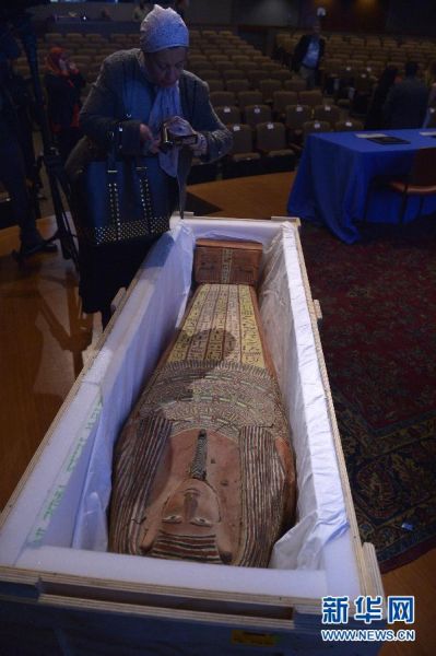  4月22日，在位于美国首都华盛顿的国家地理学会，一名女子拍摄即将回归埃及的石棺。