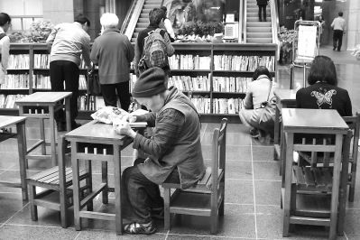 台北市环保局主办的“延慧书库年终二手书展”现场，一位耄耋老者在认真看书。