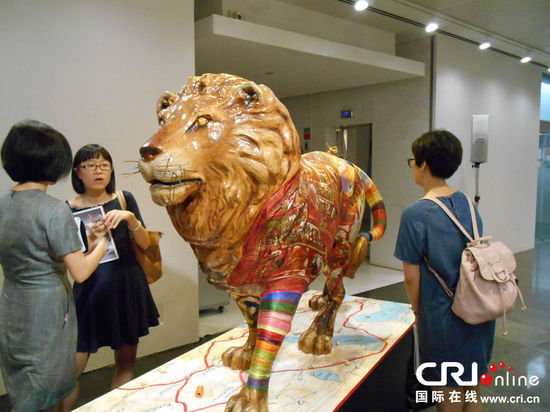 观众欣赏法国艺术家创作的狮子雕塑 